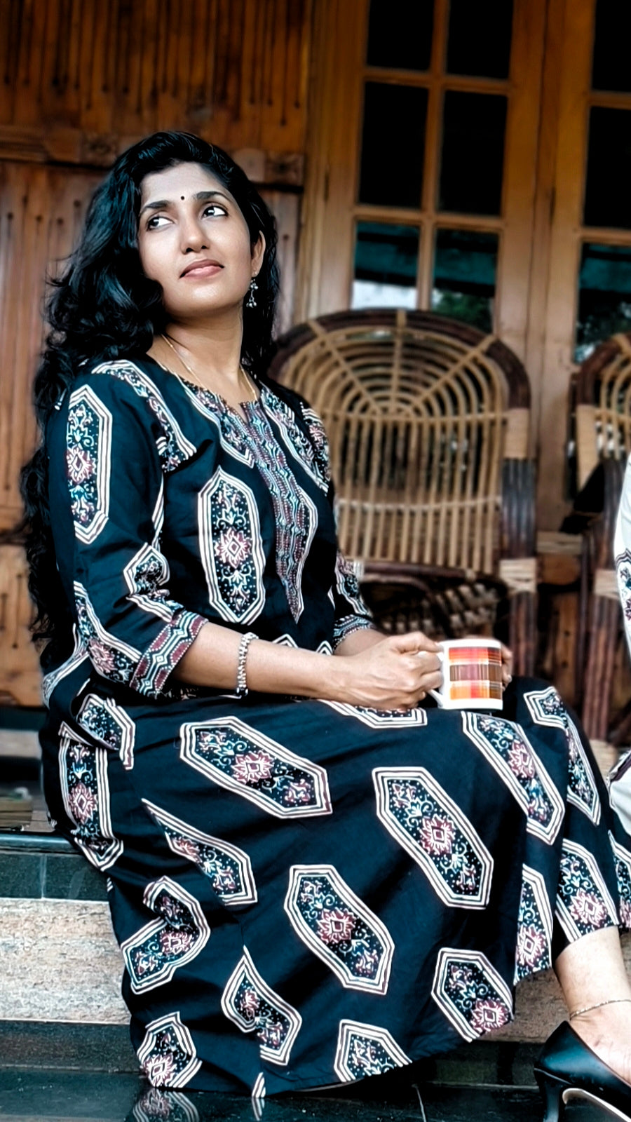 women wearing black screen printed ajrak aline kurat